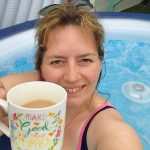 lady in hot tub with a cuppa